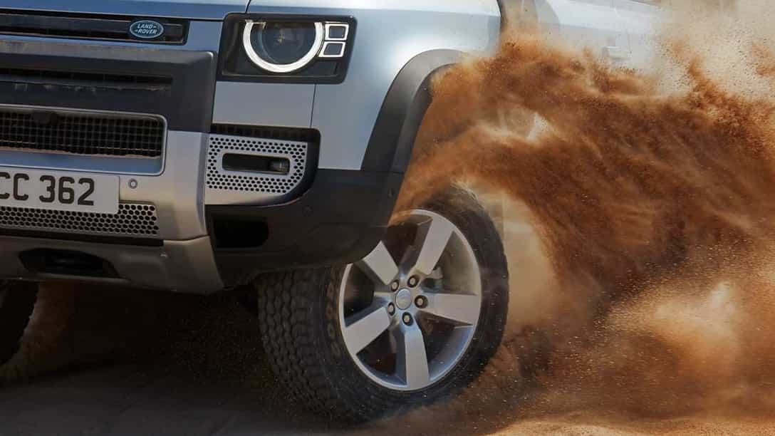 Family Picnic On A Beach Side With Defender